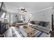 Bright living room with fireplace, mounted TV, ceiling fan, and comfortable seating arrangement at 827 Lockesley Ln, Burlington, NC 27217