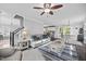 Bright living room open to kitchen and dining, ceiling fan, hardwood flooring, and comfortable seating at 827 Lockesley Ln, Burlington, NC 27217