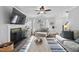 Bright living room with fireplace, mounted TV, and a comfortable seating arrangement at 827 Lockesley Ln, Burlington, NC 27217