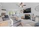 Bright living room with fireplace, ceiling fan, hardwood flooring, and open to dining area at 827 Lockesley Ln, Burlington, NC 27217