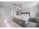 Comfortable main bedroom features rustic wood furniture, ceiling fan, and access to a private bathroom at 827 Lockesley Ln, Burlington, NC 27217