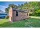 Wooden storage shed with windows and double doors, providing ample storage space in a large backyard at 827 Lockesley Ln, Burlington, NC 27217