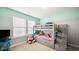 bedroom with a bunk bed and gray walls with mint accents at 912 Beech Glen Dr, Mebane, NC 27302