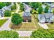Aerial front view of a two-story brick home with lush front lawn at 1009 Sarazen Dr, Clayton, NC 27527
