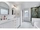 Modern bathroom featuring double vanity, gold fixtures, decorative mirrors, and a walk-in shower at 1009 Sarazen Dr, Clayton, NC 27527