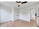 Bright bedroom featuring hardwood floors, ceiling fan, and a closet at 1009 Sarazen Dr, Clayton, NC 27527