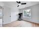 Bright bedroom features wood floors, a ceiling fan, and a large window at 1009 Sarazen Dr, Clayton, NC 27527