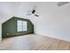 Attic bedroom with wood floor, fan, high ceilings, and lots of light from a double hung window at 1009 Sarazen Dr, Clayton, NC 27527