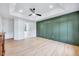 Spacious bedroom with hardwood floors, green accent wall, recessed lights and a ceiling fan at 1009 Sarazen Dr, Clayton, NC 27527