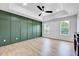 Spacious bedroom with hardwood floors, green accent wall, recessed lights and a ceiling fan at 1009 Sarazen Dr, Clayton, NC 27527