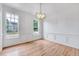 Bright and airy dining room with hardwood floors, modern chandelier, and large windows at 1009 Sarazen Dr, Clayton, NC 27527