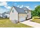 Two-story home showing the side exterior and attached garage at 1009 Sarazen Dr, Clayton, NC 27527