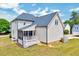 Rear exterior view of two-story house with screened-in porch and lawn at 1009 Sarazen Dr, Clayton, NC 27527
