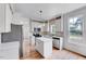 Bright kitchen with stainless steel appliances, center island, and stylish white cabinetry at 1009 Sarazen Dr, Clayton, NC 27527