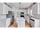 Kitchen featuring stainless steel appliances, center island, and an adjoining dining area filled with light at 1009 Sarazen Dr, Clayton, NC 27527