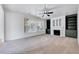 Spacious living room featuring a fireplace, built-in shelving, and ample natural light from large windows at 1009 Sarazen Dr, Clayton, NC 27527