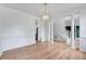 Spacious living room with hardwood floors, elegant trim, and open staircase at 1009 Sarazen Dr, Clayton, NC 27527