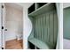 Stylish mudroom with green storage bench and half bath at 1009 Sarazen Dr, Clayton, NC 27527