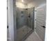 Modern bathroom showcasing a glass-enclosed shower with gray tiling and sleek fixtures at 1010 Westerland Way # 200, Durham, NC 27703