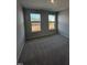 Cozy bedroom featuring wall to wall carpet, natural light from two windows and neutral walls at 1010 Westerland Way # 200, Durham, NC 27703