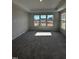 Sunlit bedroom featuring plush carpeting, neutral walls, and a large window overlooking the outdoors at 1010 Westerland Way # 200, Durham, NC 27703