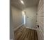 Hallway showcasing hardwood floors with access to rooms and storage with white painted doors at 1010 Westerland Way # 200, Durham, NC 27703