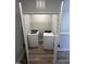 Convenient laundry closet featuring a washer, dryer, and overhead shelving, optimizing space efficiency at 1010 Westerland Way # 200, Durham, NC 27703