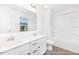 Bright bathroom featuring double vanity, sleek fixtures, natural light, and bathtub with tile surround at 103 Mable Ct # 25P, Lillington, NC 27546