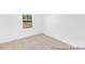 Cozy bedroom featuring neutral carpeting, white walls, base molding, and natural light from the window at 103 Mable Ct # 25P, Lillington, NC 27546