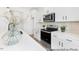 Bright kitchen features white cabinets, stainless steel appliances, granite countertops, and a stylish backsplash at 103 Mable Ct # 25P, Lillington, NC 27546