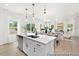 Open-concept kitchen and living area filled with natural light, showcasing modern finishes and a dining space at 103 Mable Ct # 25P, Lillington, NC 27546