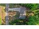 Aerial view showcases a home with a large driveway and lush surrounding trees at 105 Oak Ridge Rd, Franklinton, NC 27525