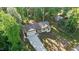 Aerial view of a well-maintained home with a long driveway and lush greenery at 105 Oak Ridge Rd, Franklinton, NC 27525