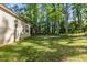 A large backyard features mature trees and green grass, perfect for outdoor activities and relaxation at 105 Oak Ridge Rd, Franklinton, NC 27525