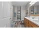 Bright bathroom featuring a wooden framed mirror, white countertops and wood cabinets at 105 Oak Ridge Rd, Franklinton, NC 27525
