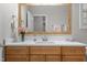 Bright bathroom featuring a wooden framed mirror, white countertops and wood cabinets at 105 Oak Ridge Rd, Franklinton, NC 27525