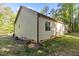 Side view of a home featuring light siding, black gutters, and a well-maintained lawn at 105 Oak Ridge Rd, Franklinton, NC 27525