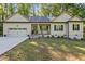 Charming single-story home featuring a well-manicured lawn, attached garage, and covered porch at 105 Oak Ridge Rd, Franklinton, NC 27525