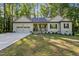 Charming single-story home with a well-manicured lawn, covered porch, and attached garage at 105 Oak Ridge Rd, Franklinton, NC 27525