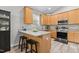 Kitchen island with granite countertop, wooden cabinets, and stainless steel appliances at 105 Oak Ridge Rd, Franklinton, NC 27525