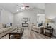 Bright living room featuring vaulted ceilings, neutral paint, wood-look floors, and stylish furniture at 105 Oak Ridge Rd, Franklinton, NC 27525