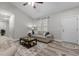Bright and neutral living room featuring hardwood floors, a ceiling fan, and an abundance of natural light at 105 Oak Ridge Rd, Franklinton, NC 27525