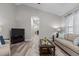Bright and neutral living room boasts continuous flooring, comfortable seating, and natural light at 105 Oak Ridge Rd, Franklinton, NC 27525