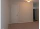 A view of a living room featuring neutral carpet and paint, leading to other rooms at 108 Ephesus Church Rd # Apt 416, Chapel Hill, NC 27517