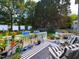 Relax on this back deck with plants, flowers, and ample seating; perfect for outdoor entertainment at 1106 Purple Glory Dr, Apex, NC 27502