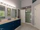 Modern bathroom with double vanity, mirrors, and a glass-enclosed shower at 1106 Purple Glory Dr, Apex, NC 27502