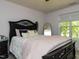 This stylish bedroom features a black framed bed and a large window offering plenty of natural light at 1106 Purple Glory Dr, Apex, NC 27502