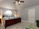 Serene bedroom with a king-size bed, arched window, and neutral decor at 1106 Purple Glory Dr, Apex, NC 27502