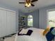 Bright bedroom with a queen-sized bed, shelves and large window with natural light at 1106 Purple Glory Dr, Apex, NC 27502