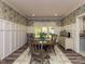 Bright dining room with decorative wallpaper, wainscoting, and a large window at 1106 Purple Glory Dr, Apex, NC 27502